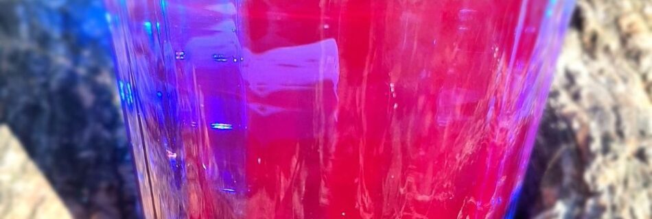 un verre de phycocyanine qui montre tout son spectre colorimétrique